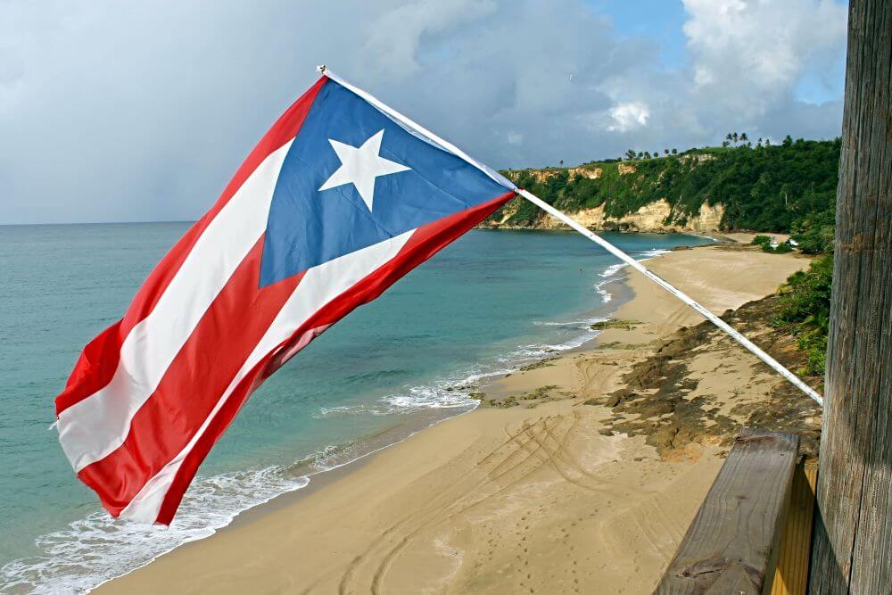 Puerto Rican flag flying over a beach